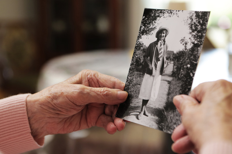 24-Hour Live-in Care in Dorset Dementia Patient Looking at Old Photographs